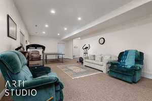 Living room with carpet, recessed lighting, visible vents, and baseboards