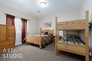 Bedroom with visible vents and carpet floors