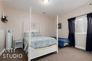 Bedroom with carpet flooring, baseboards, and visible vents