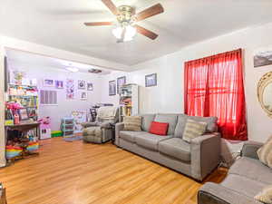 Living area featuring ceiling fan and wood finished floors