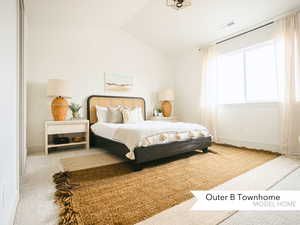 Carpeted bedroom with visible vents, baseboards, and vaulted ceiling