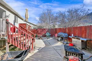 Exterior space featuring grilling area and fence