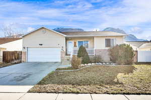 Single story home with a mountain view, driveway, a garage, and fence