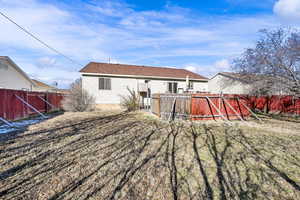 Back of property with a fenced backyard