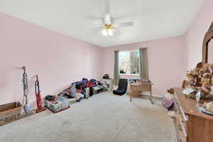 Miscellaneous room with baseboards, carpet, and ceiling fan