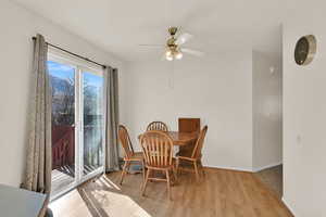 Dining area featuring ceiling fan, baseboards, and wood finished floors