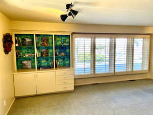 Interior space featuring visible vents, light colored carpet, and baseboards