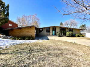 Mid-century inspired home with a front yard