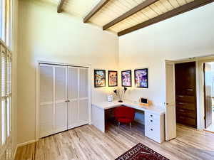 Unfurnished office featuring wood ceiling, beamed ceiling, light wood-style flooring, and high vaulted ceiling