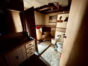 Bathroom with wainscoting, toilet, and vanity