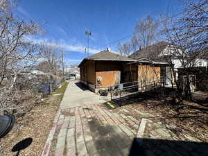 View of side of home featuring a shingled roof