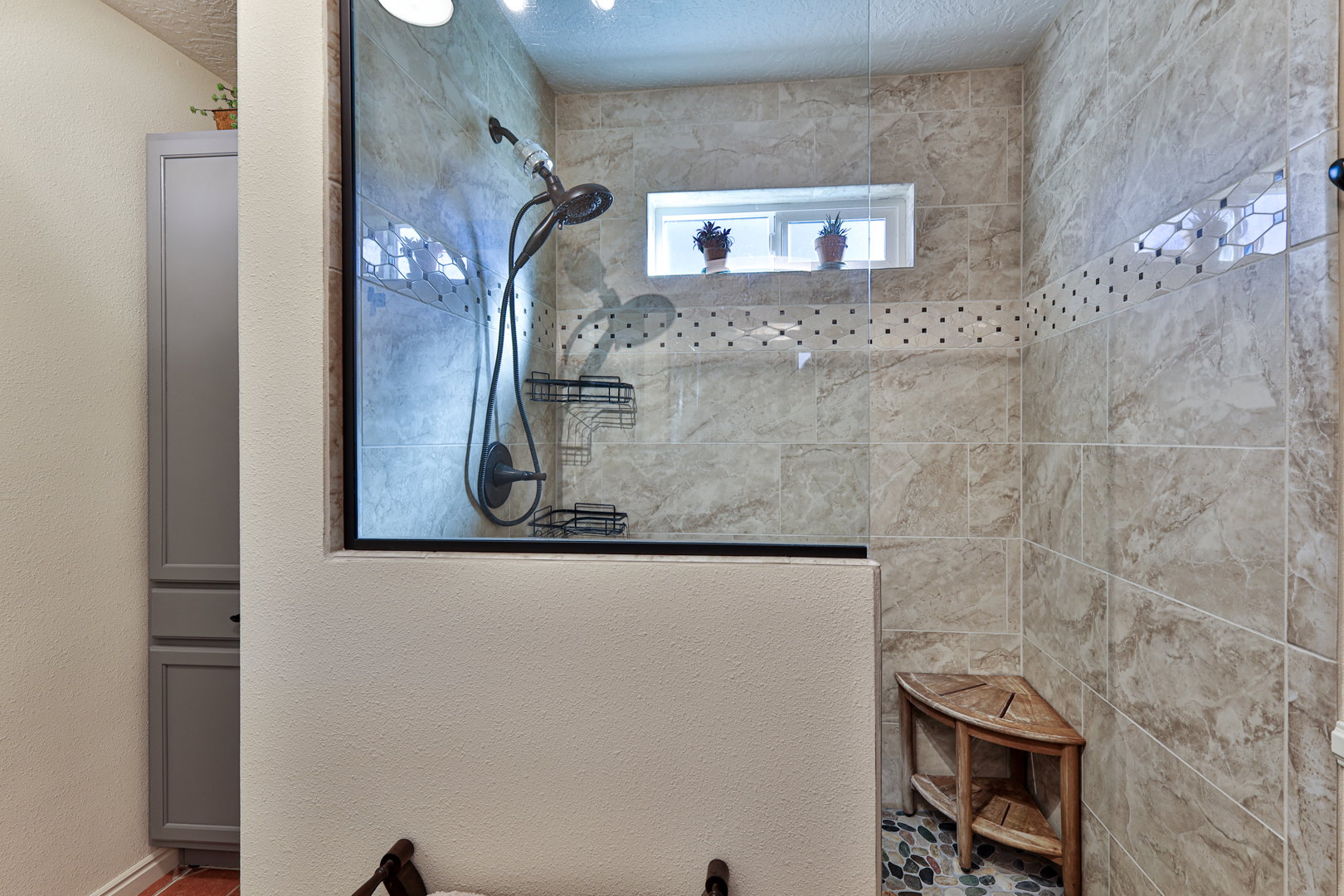 Bathroom with a textured ceiling and a walk in shower