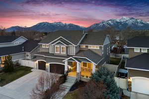 View of front of house with fence, a mountain view, and stucco siding