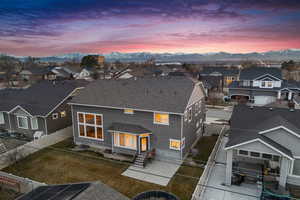 Exterior space with roof with shingles, a fenced backyard, a residential view, stucco siding, and a mountain view