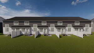 Back of property featuring a wooden deck and a yard