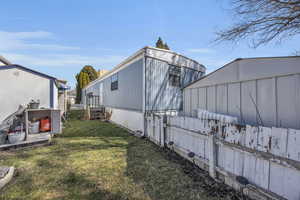 View of side of property with a yard