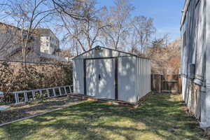 View of shed featuring a fenced backyard