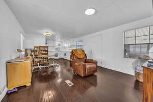 Interior space featuring visible vents, baseboards, and dark wood-style flooring