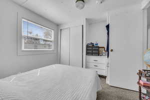 Bedroom featuring carpet and a closet