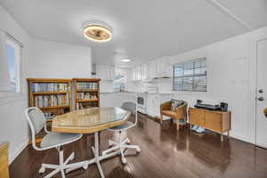 Dining space with baseboards and dark wood finished floors