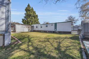 View of yard featuring an outbuilding and a storage unit