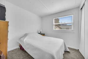 Bedroom with carpet and baseboards