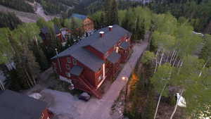 Birds eye view of property with a forest view