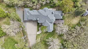 View from above of property with a tree filled landscape