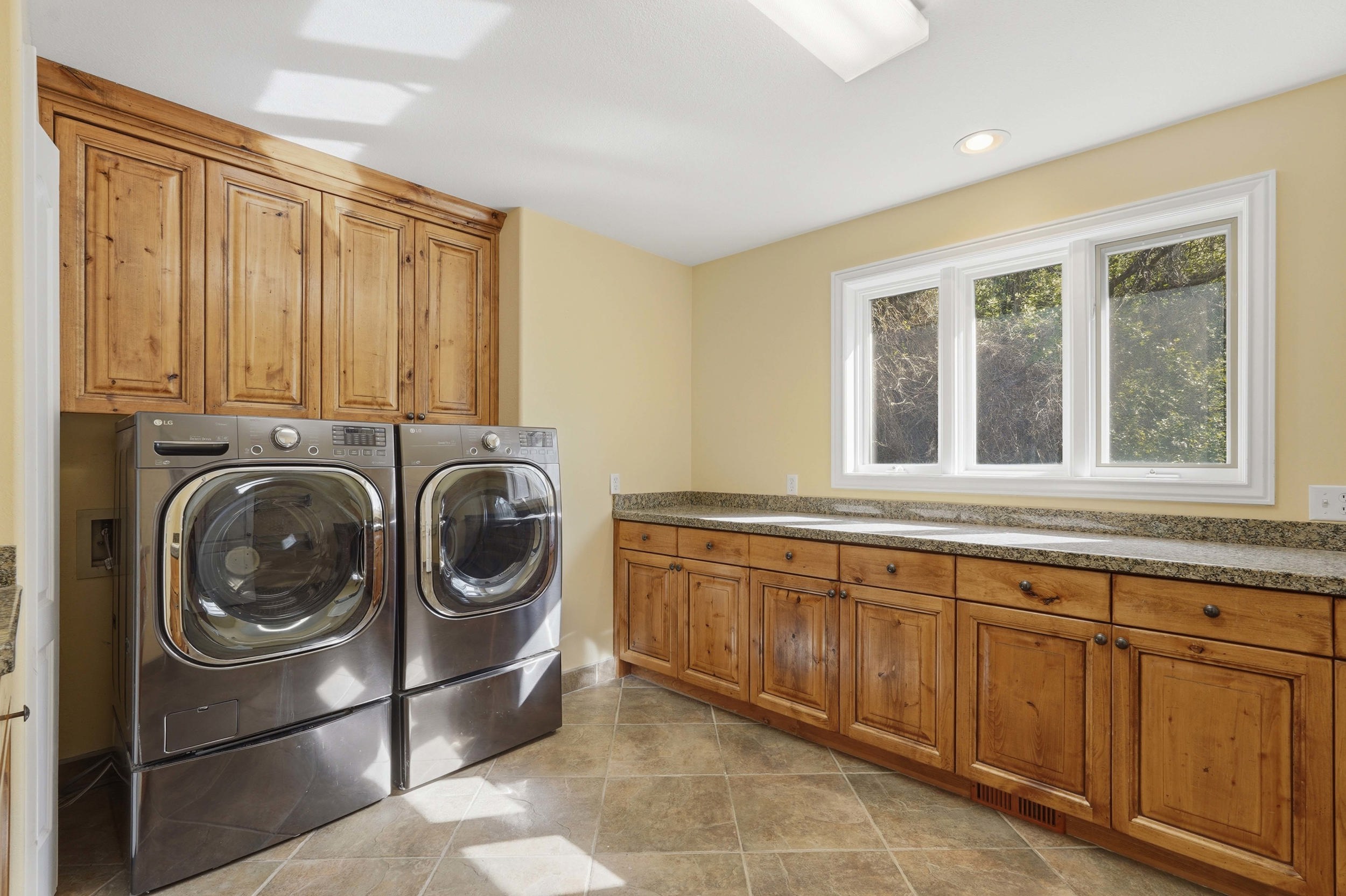 Laundry room with ample cabinets and counterspace