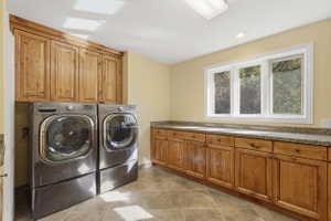 Laundry room with ample cabinets and counterspace