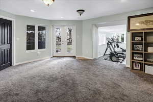 Interior space with a wealth of natural light, recessed lighting, baseboards, and carpet floors