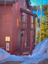 View of snow covered exterior featuring stairs