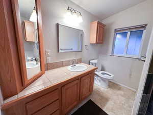 Bathroom with vanity and toilet