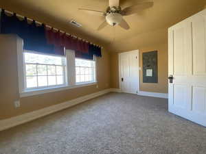 Carpeted empty room featuring a ceiling fan, baseboards, and visible vents