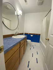 Bathroom with tile patterned floors, visible vents, toilet, and vanity