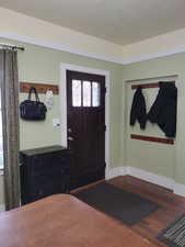 Entryway featuring baseboards and wood finished floors