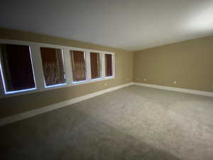 Empty primary bedroom. Pella window with view of mountains.