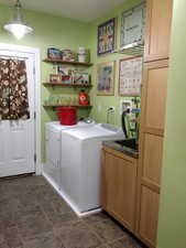 Clothes washing area with cabinet space and washing machine and dryer