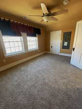 Unfurnished bedroom featuring baseboards, visible vents, and ceiling fan