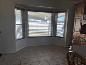 Dining room with light tile patterned flooring and baseboards