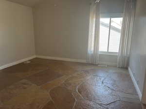 Primary Bedroom with two closets  and stone finish floor