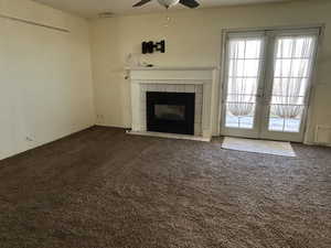 Family room with carpet, french doors, and a ceiling fan