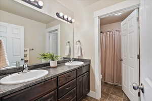 Bathroom featuring double vanity and a sink