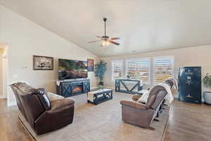 Living room featuring visible vents, a ceiling fan, wood finished floors