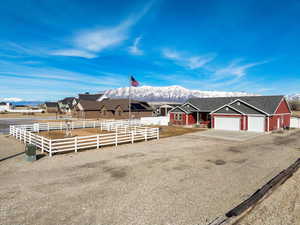 View of front of home featuring fence and a mountain view