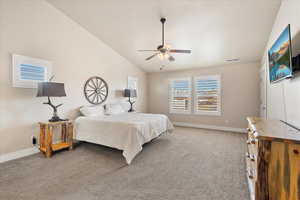 Bedroom featuring visible vents, lofted ceiling, carpet floors, baseboards, and ceiling fan