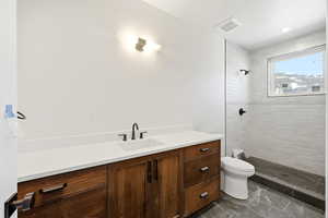 Full bathroom featuring vanity and a tile shower