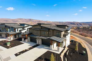 View of front of house featuring a garage, driveway, and a mountain view