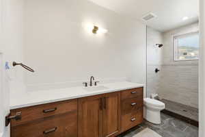 Full bath featuring vanity, a stall shower, and recessed lighting