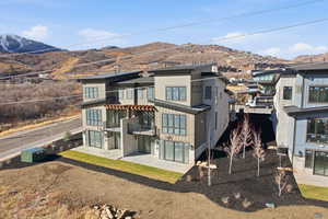 Back of house featuring a mountain view and a patio
